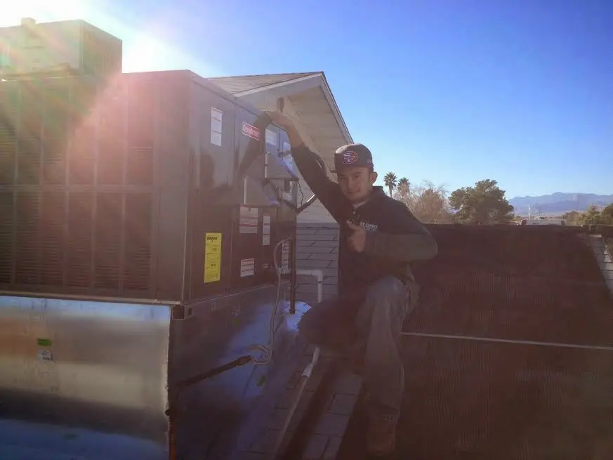 HVAC technician performing Boiler Repair on a rooftop unit in Lake Forest